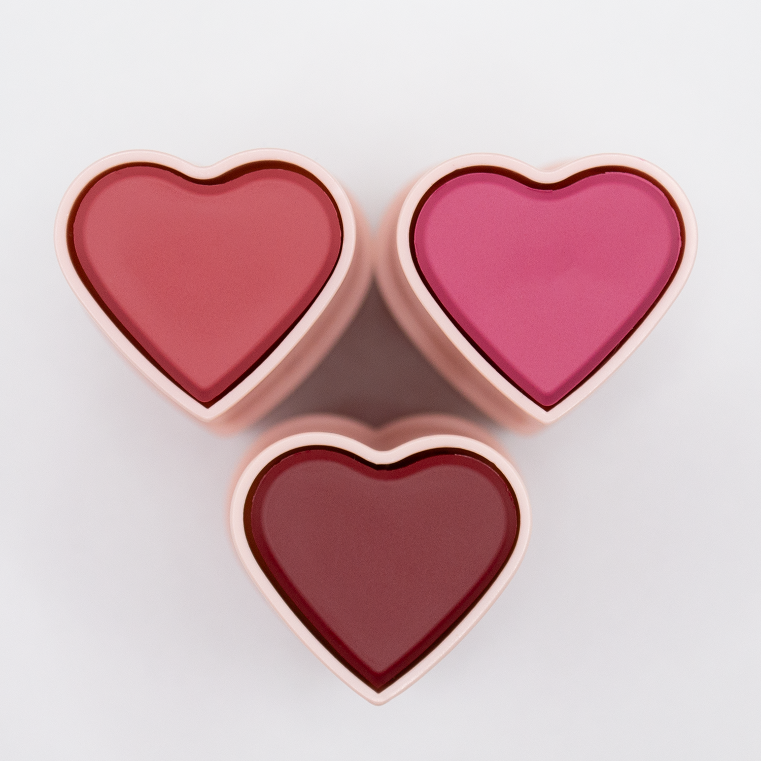 The three Dare To Blush shades of the Opulent Berry bundle viewed from the top - Resilient Rosé, Bold Berry and Courageous Crimson