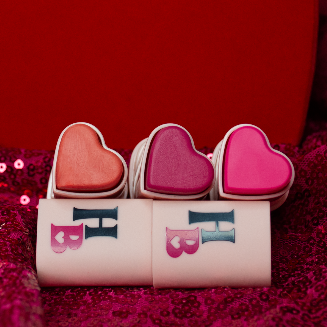 the happy hearts blush trio: shades confident coral, bold berry and protagonist pink on a valentines day decor with sparkly hot pink fabric and a big red heart box