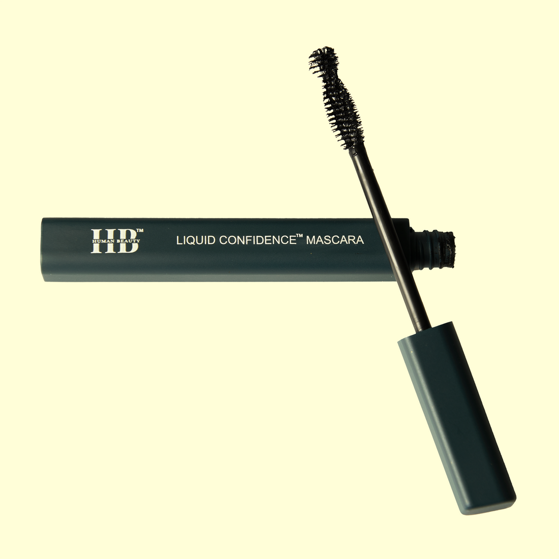 The Liquid Confidence Mascara open on a light yellow background.