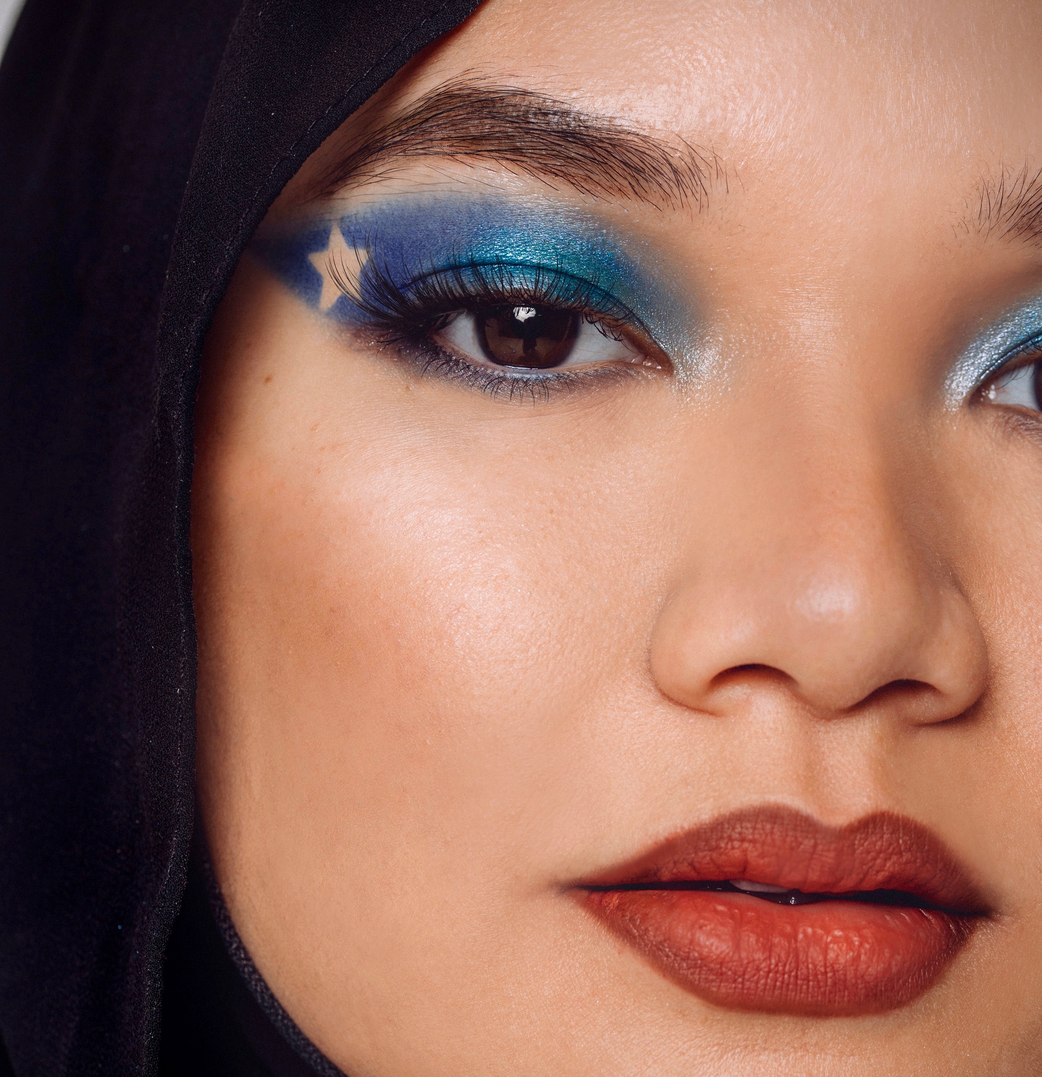 A bold blue smokey eye look with a star cut out using shades Identity and Empower from the Makeup Therapy Palette.