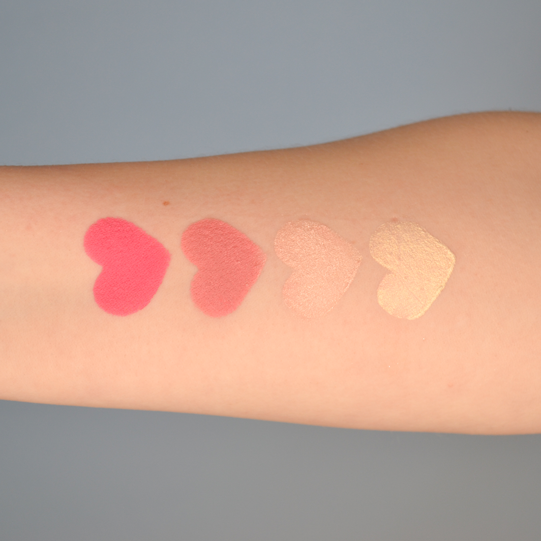 Swatches of shades Protagonist Pink, Positive Peony, Ethereal and Celestial in heart shapes on fair skin